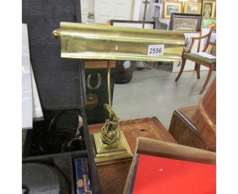 A brass desk lamp.