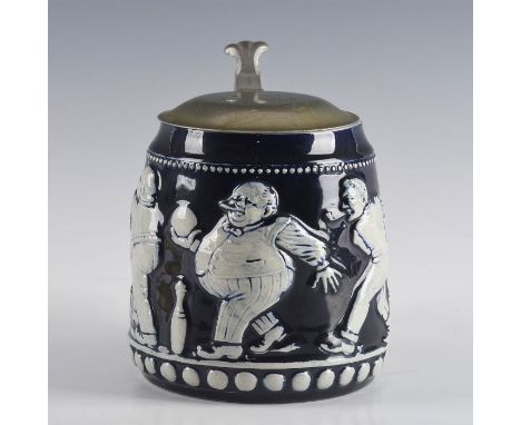 Cobalt blue ceramic mug with silver lid.Mug in high relief form with applied decorations. Scene of Winston Churchill and Theo