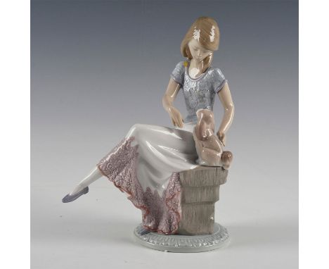 Figure of a seated girl with brown and white puppy - Lladro number 01007612.Lladro backstamp (with box). Artist: Juan HuertaD