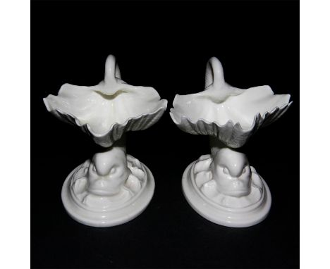 Vintage blanc de chine porcelain, modeled in Neoclassical style as a dolphin fish balancing a clam shell on its back. Stamped