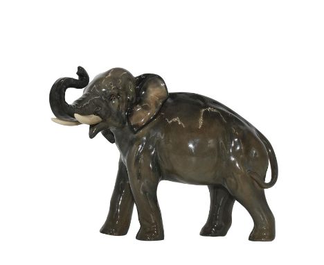 Modeled as an olive-grey elephant with trunk in salute.Style one, medium. Earthenware. Artist: Charles NokeIssued: 1926-1943D