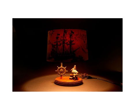 A Royal Doulton figurine, Tall Story, depicting a sea captain spinning a tale, incorporated as the centerpiece of an electric