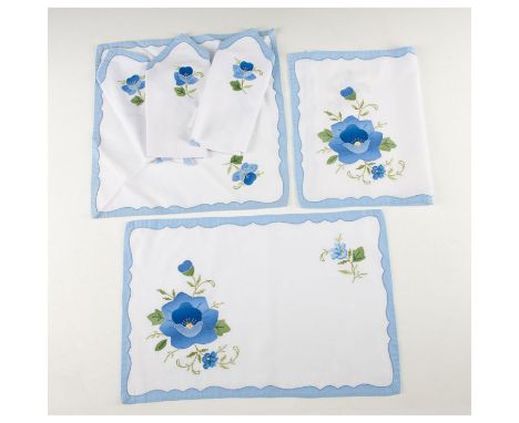 Set of 4 napkins and 2 placemats. Hand embroidered with cross stitch and applique floral patterns in royal and light blues, a
