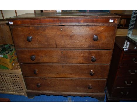 An Oak secretaire chest of four long drawers, the upper drawer being the secretaire drawer with five inner drawers and three 