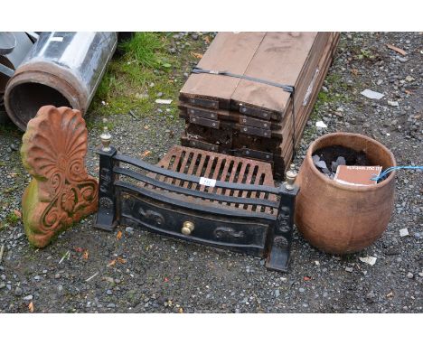 A terracotta planter, and fire grate with front.