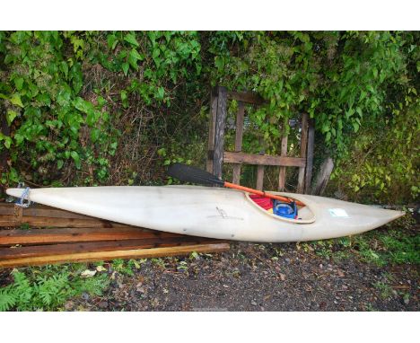 A plastic Canoe with oar and safety helmet.