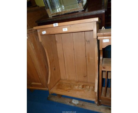 A wall hanging Pine shelf with plate pegs to base and cup hooks to top, 21'' wide.