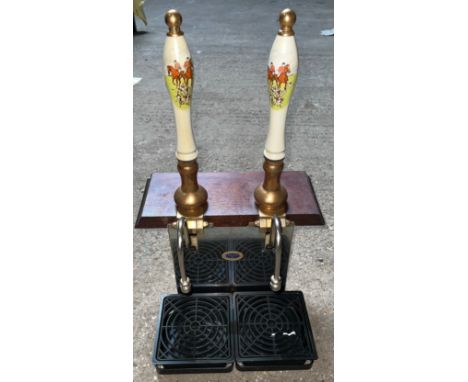A pub double beer pump with ceramic handles of hunting design.