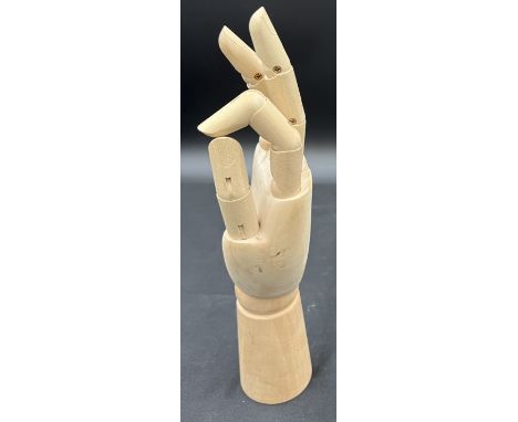 A wooden articulated artists hand model. 29cm h.