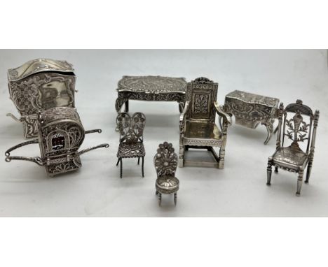 Miniature silver and white metal continental furniture.Condition ReportOne handle broken to larger sedan chair.