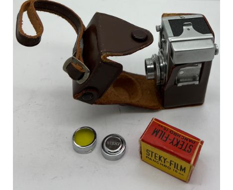 A Steky model III B vintage sub miniature film camera and case, lens cover, lens and Steky 16mm film reel.Condition ReportApp