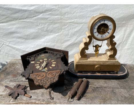 Two clocks; an alabaster mantle clock with drum cased movement and figural swinging gilt cherub together with a cuckoo clock.