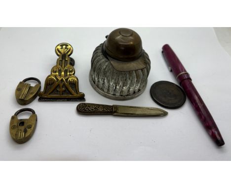 Miscellany to include; Osmiroid pen, Cartwheel penny, inkwell with jockey cap, bookmark, brass clip and padlocks.Condition Re