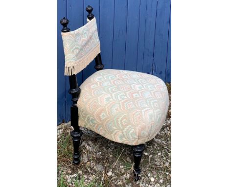 A 19thC ebonised nursing chair, probably Swiss.  78cm to back x 37cm to seat.Condition ReportSome damage to one finial.