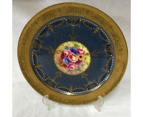 Royal Worcester plate signed J Stanley, 27cm d. Depicting flowers to the centre and raised decoration to the edge.Condition R