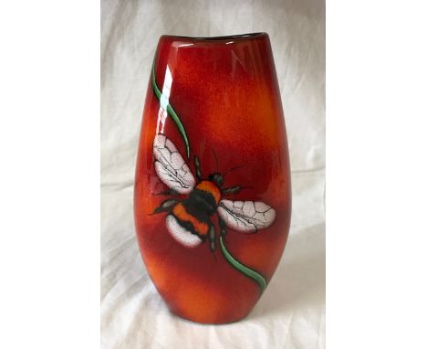 A Poole Pottery vase with Bee decoration to front on a red and orange glazed background. 25cms h.Condition ReportGlaze mark t