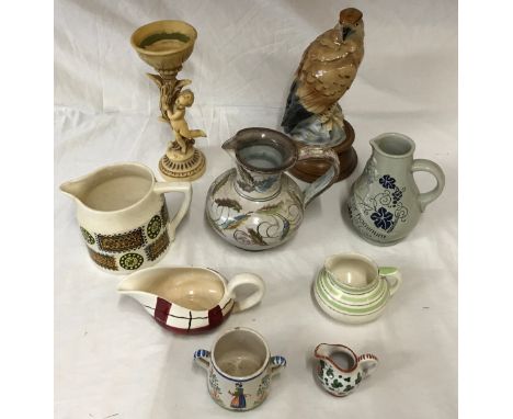 A mixed lot of ceramics to include a eagle on wooden stand 30cms h, 6 x jugs by Portmeirion, Crown Ducal, Meakin, a resin can