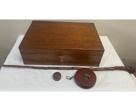 A 19thC mahogany writing box, walking stick, leather cased tape measure and a cod bottle opener.Condition ReportSlope a/f, ot