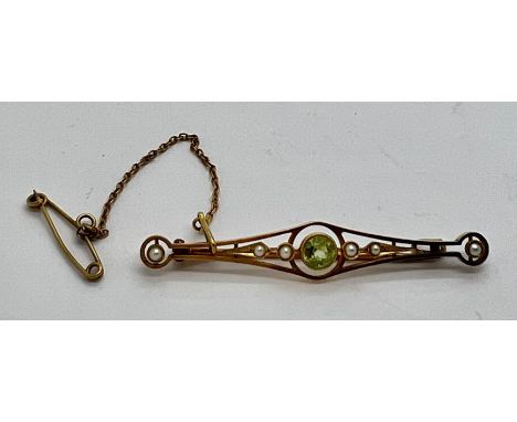 A 15ct seed pearl and peridot bar brooch with safety chain. 3.2gm weight.Condition ReportGood condition.