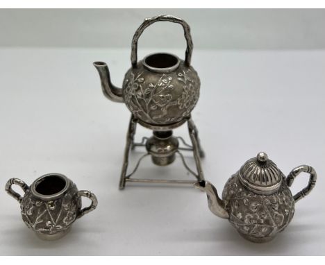 Miniature Chinese silver teapot, kettle on stand and sugar bowl with prunus blossom decoration marked CW 90, teapot 3cm h, ma