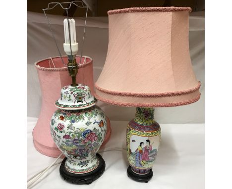 Two Chinese style ceramic table lamps with wooden carved base and pink lampshades, tallest lamp base 42cms h.Condition Report