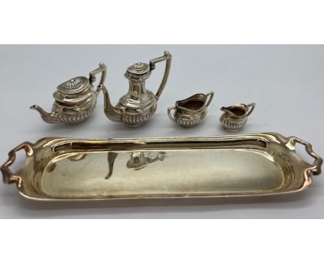 Miniature silver tea service on tray, London 1976, maker Da-mar Silverware. 65gm total weight. Tray 15 x 4cm.Condition Report