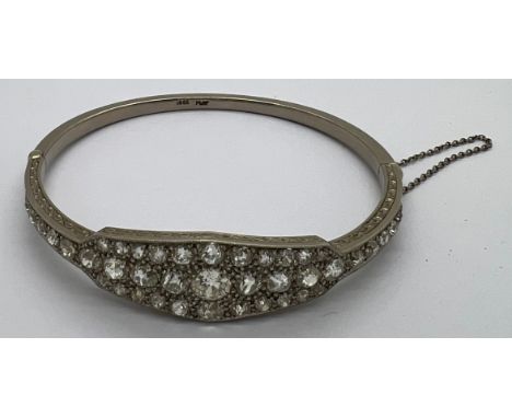 A fine quality 18ct white gold and platinum hinged bangle. 41 diamonds, 5ct total. Largest diamond 5.8mm. 20.3gm total.Condit