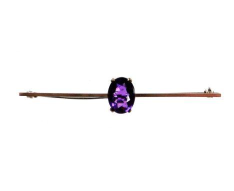 An amethyst set bar brooch, with oval cut amethyst in full claw setting, on a white gold backing, stamped 9ct, 6cm wide, 2.7g