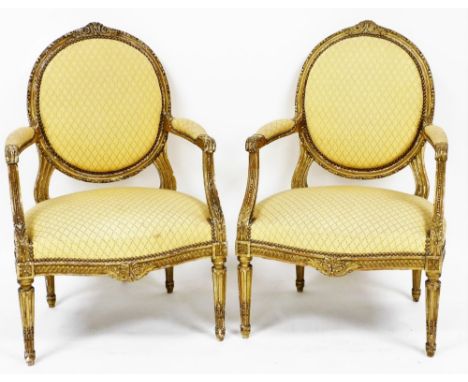 A pair of early 19thC French style gilt painted hall chairs, each with a yellow diamond upholstered back and seat, with butto