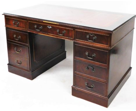 A late 20thC reproduction mahogany twin pedestal desk, with red leather gilt inset, and additional glass shelf top above one 