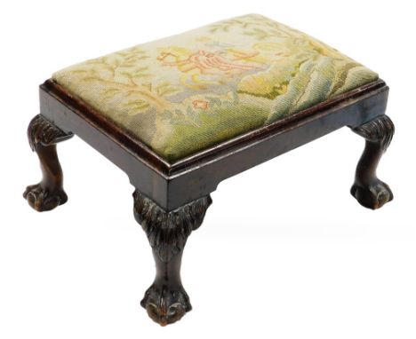 A Chippendale style mahogany footstool, with needlework top and ball and claw feet. 
