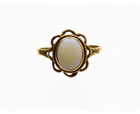 A 9ct gold opal dress ring, set with central oval opal in rub over setting, surrounded by rope twist border and pleated petal