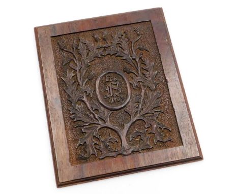 An early 20thC carved oak panel, with central crest stamped Feb 1907 and bearing the initials DS ? with a dandelion surround,