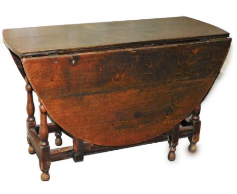 An early 19thC oak gate leg table, on rectangular set base, 70cm high, 116cm wide, 145cm diameter.