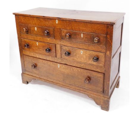 An early 19thC oak Lancashire chest, of four short and one long drawer, lift top two drawers dummy, with mother of pearl escu