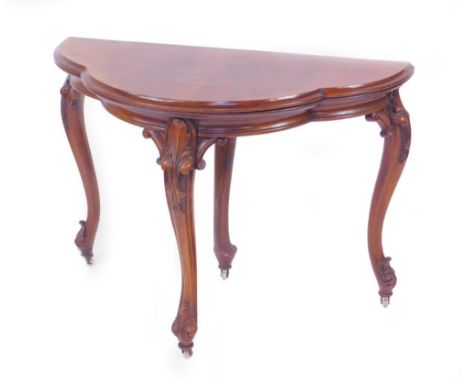 A Victorian figured walnut quatrefoil card table, with folding top having green baize lining, plain moulded frieze and suppor