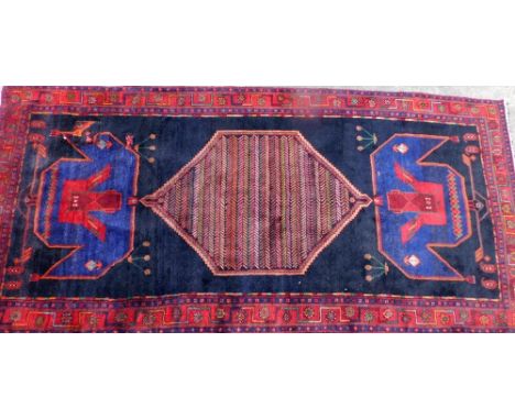 A deep blue ground rug, with large central medallion, on Greek key borders, with patch repair, 323cm x 153cm. 