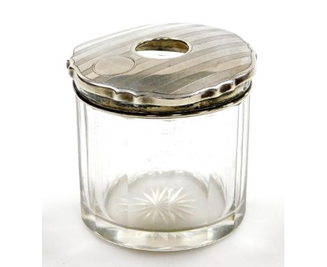 A George V silver topped dressing table jar, the engine turned design top Birmingham 1926, on a cut glass jar, 7cm high.