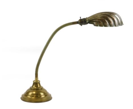 A retro brass desk lamp, with shell clam shade, on arched column, 74cm high.