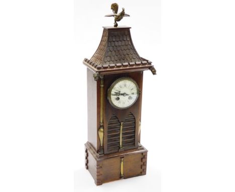 An oak cased temple dragon mantel clock, with a domed enamel dial stamped K-DEPOSE, with dragon and cockerel finials, 51cm hi