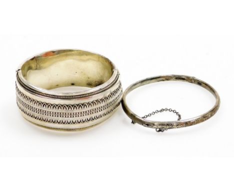 A hinged bangle, with applied filigree type decoration, white metal, stamped sterling, together with another thin silver hing