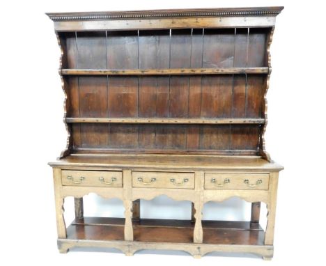 A 19thC oak Welsh dresser, with two shelf top, on three drawer base with brass handles, 192cm high, 175cm wide, 45cm deep.