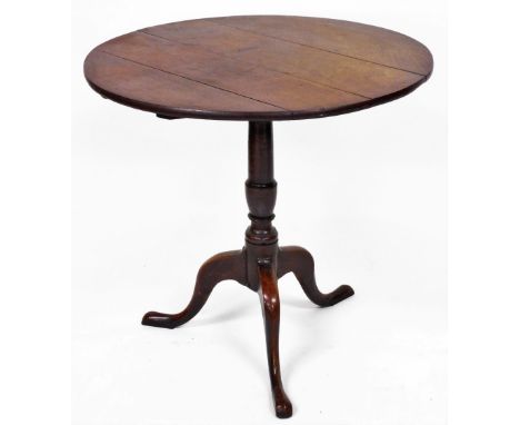 A 19thC oak tripod table, 72cm high, 75cm diameter.