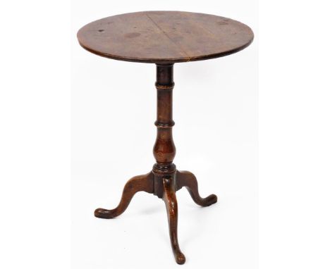 An early 19thC oak occasional table, the circular panelled top on a tripod base, 65cm high, 53cm diameter.