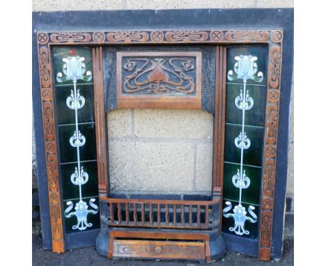 A Victorian fireplace surround, inset with five Art Nouveau type tiles to each side and with an overall Art Nouveau type deco