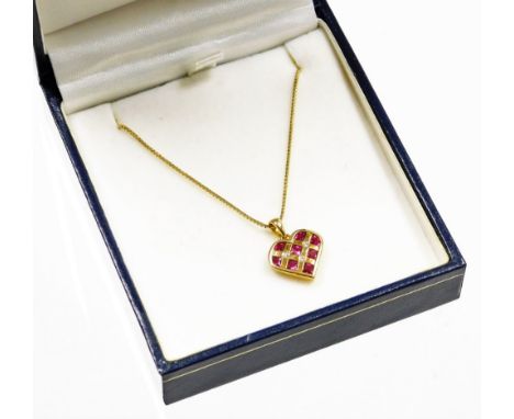 An 18ct gold ruby and diamond heart shaped pendant and chain, the heart shaped pendant set with eight square cut rubies and b