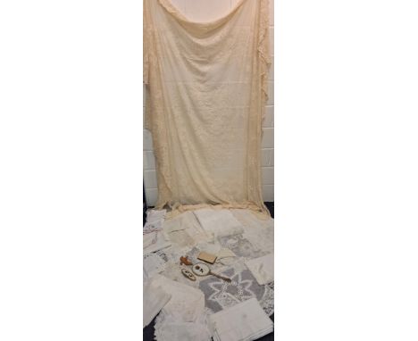 A quantity of vintage lace and crotchet table linen and cushion covers to include tablecloths and doilies together with dress