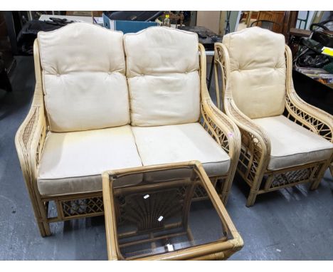 A contemporary conservatory suite comprising two  seater sofa with loose cushion seats, two matching armchairs, and side tabl