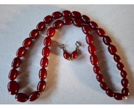 A vintage cherry amber resin bead necklace comprising 41 graduating beads together with a matched pair of cherry amber resin 