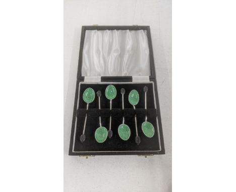 A set of six silver coffee spoons having green two-tone enamel bowls in a fitted case Location:If there is no condition repor